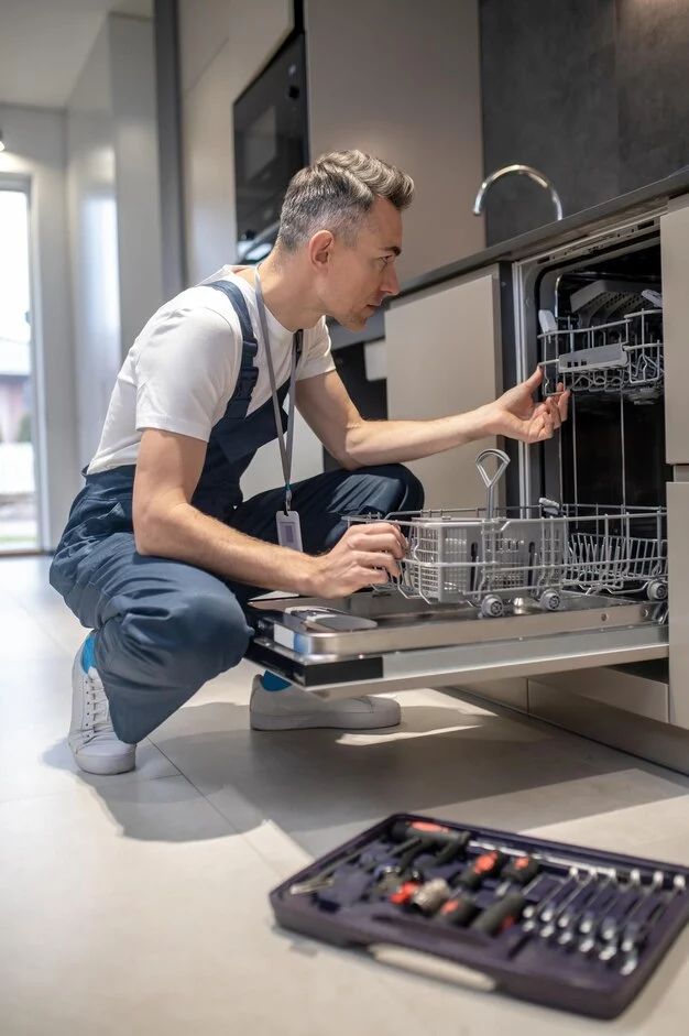 Appliance technicians taking a close look to dishwasher in Ottawa