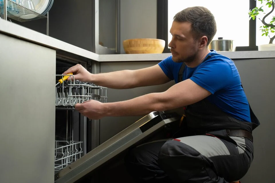 A repair man repairing dishwasher in Ottawa