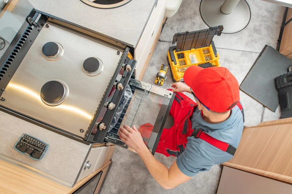 A technician replacing a home appliance in Ottawa