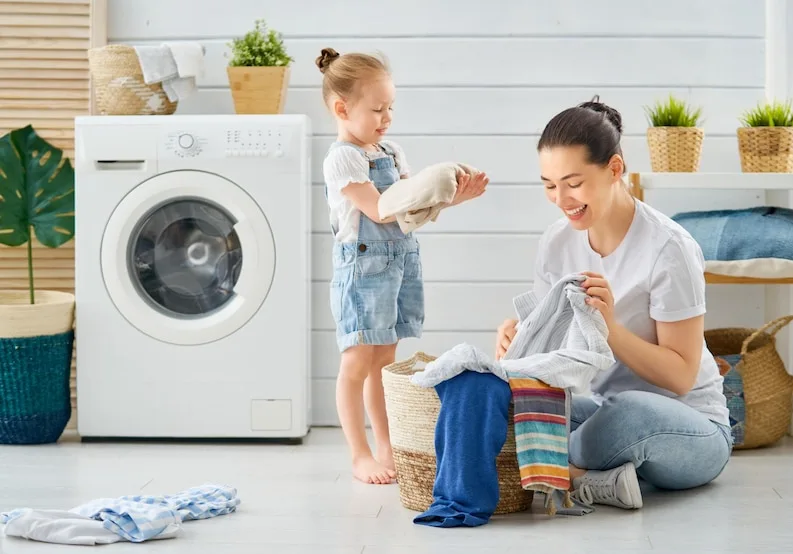 A happy family washing clothes with Samsung washer in Ottawa