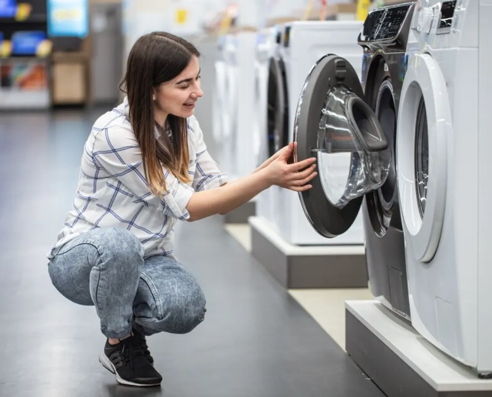 a woman looking at Whirlpool dryer in Ottawa