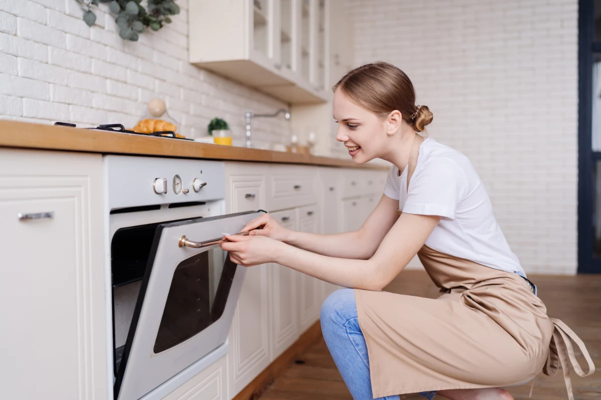A woman enjoying having a self cleaning oven