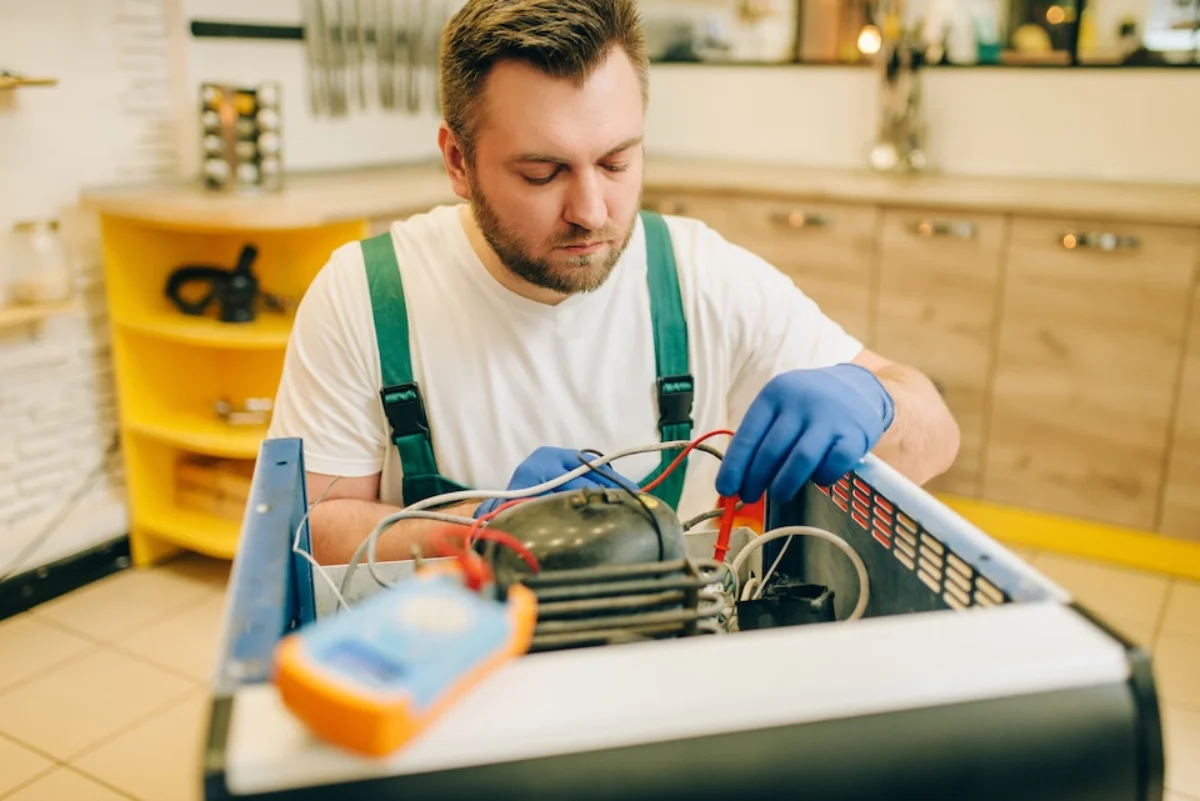 Home appliance technician repairing dishwasher